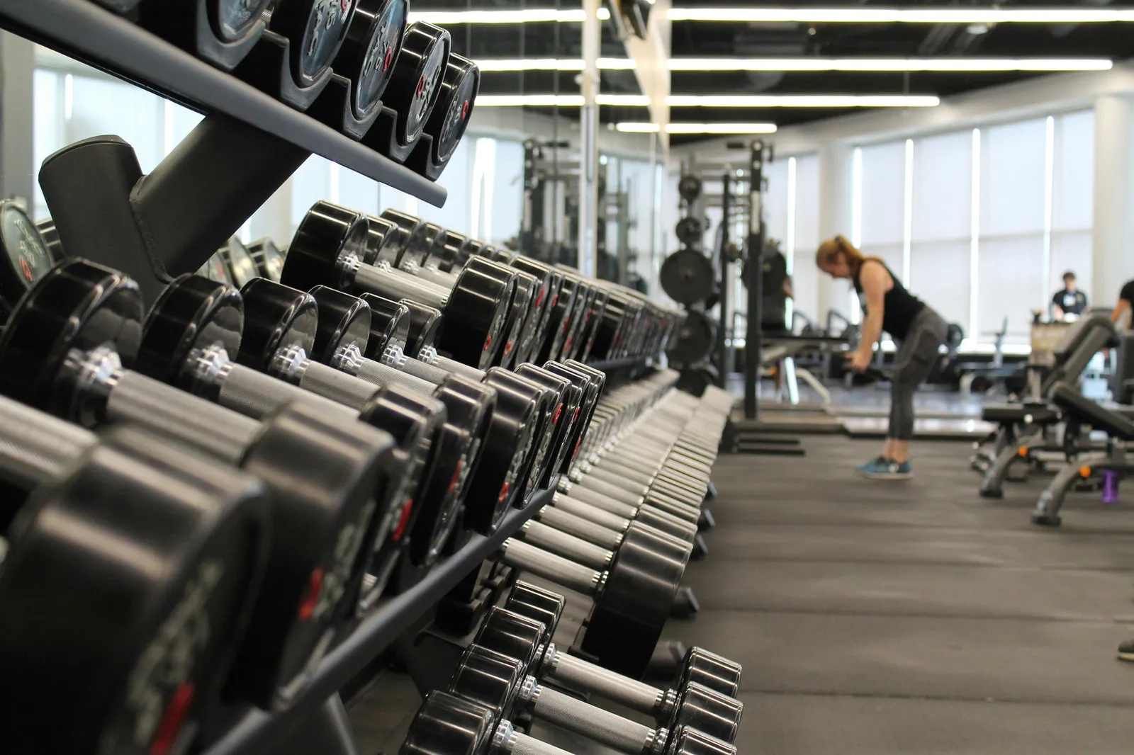 a bright clean gym with people working out
